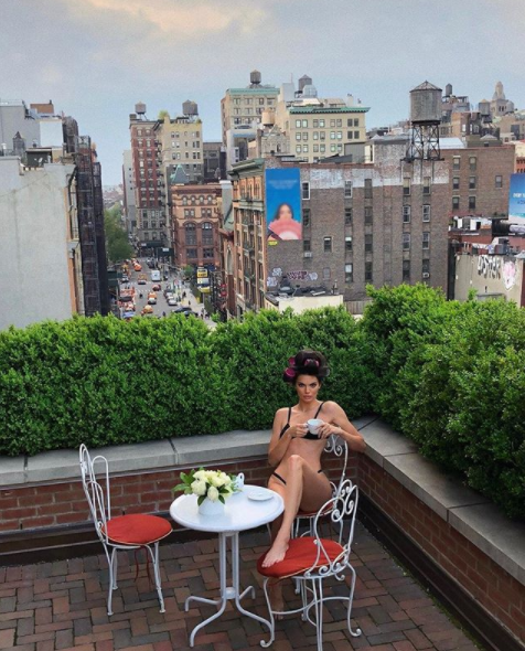 Kendall Jenner posed on her balcony in just her underwear with rollers in her hair 