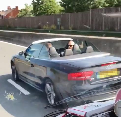  The Audi convertible driver can be seen repeatedly breaking in front of the recovery truck