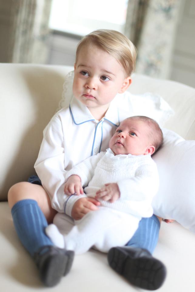  Prince George holds baby sister Charlotte in 2015