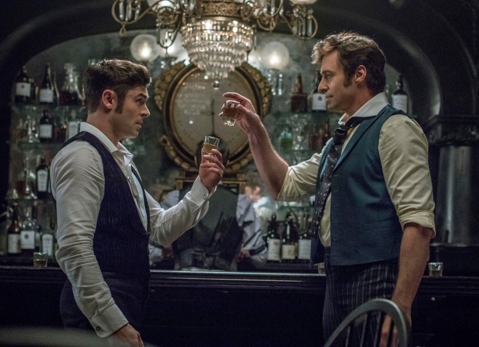 Zac Efron, left and Hugh Jackman both star in The Greatest Showman in an all-star cast