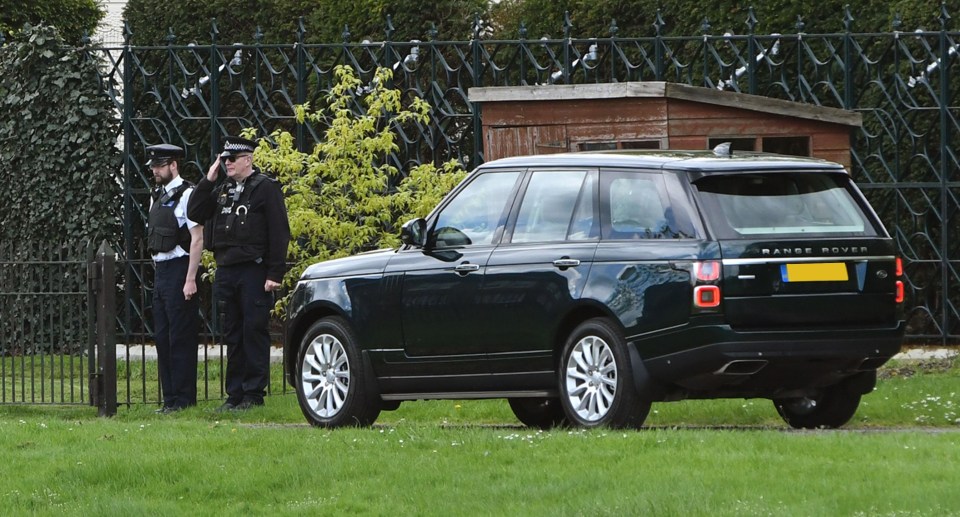 A police officer saluted the Queen as she was driven past