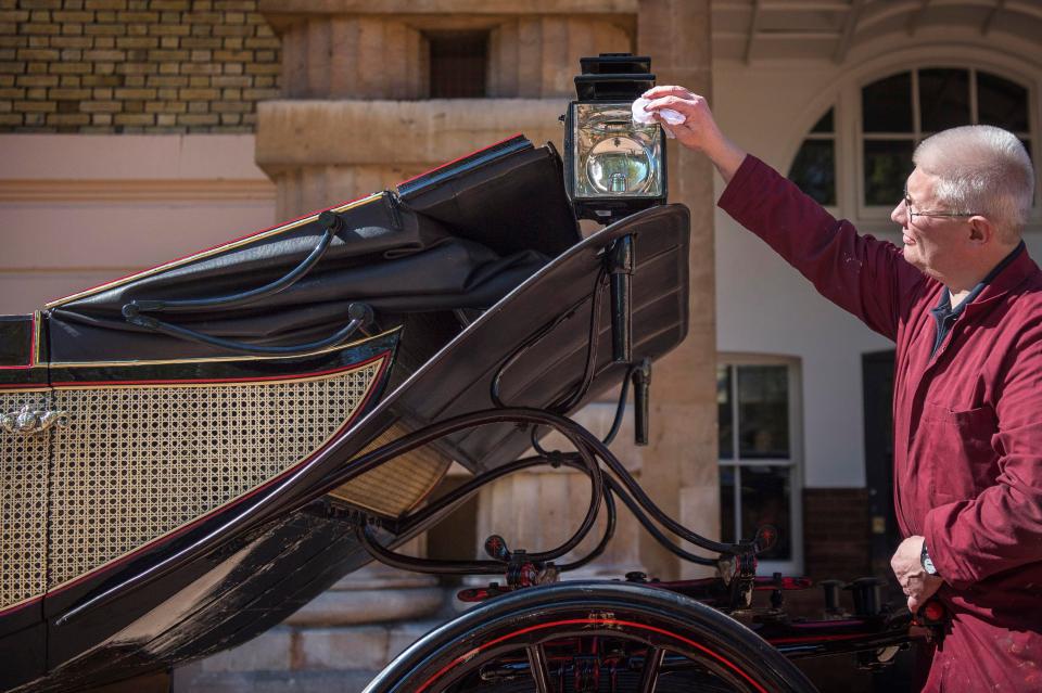  Martin Oates, Senior Carriage Restorer, polishes the Ascot Landau outside of Buckingham Palace