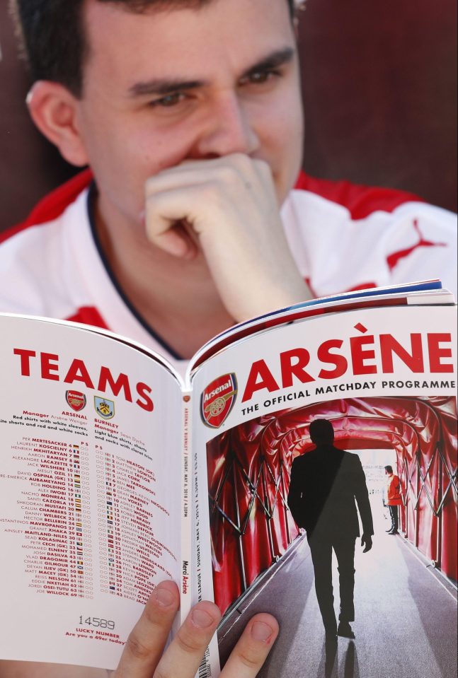  A fan reads Wenger's last programme notes