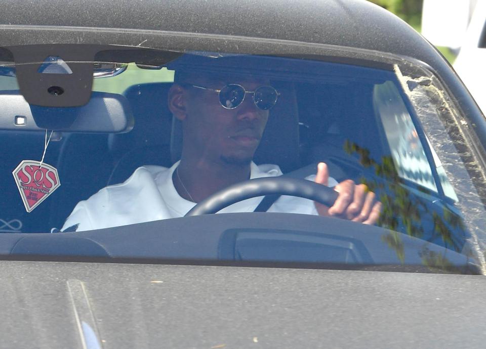 Paul Pogba arrives at Manchester United training after news of Sir Alex Ferguson's operation spreads