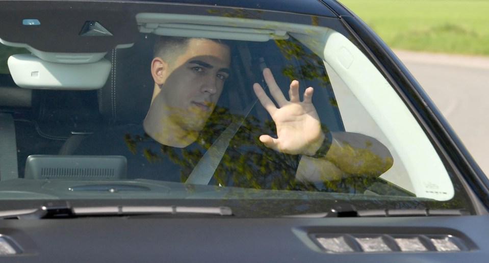 Manchester United keeper Joel Pereira waves at cameras as he arrives at training