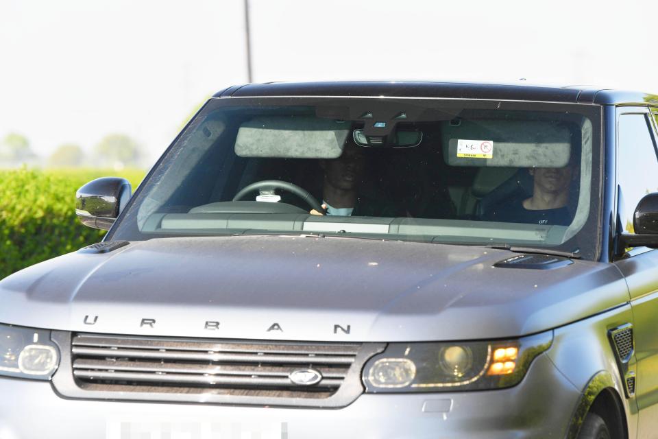 Manchester United striker Marcus Rashford drives team-mate Jesse Lingard to training