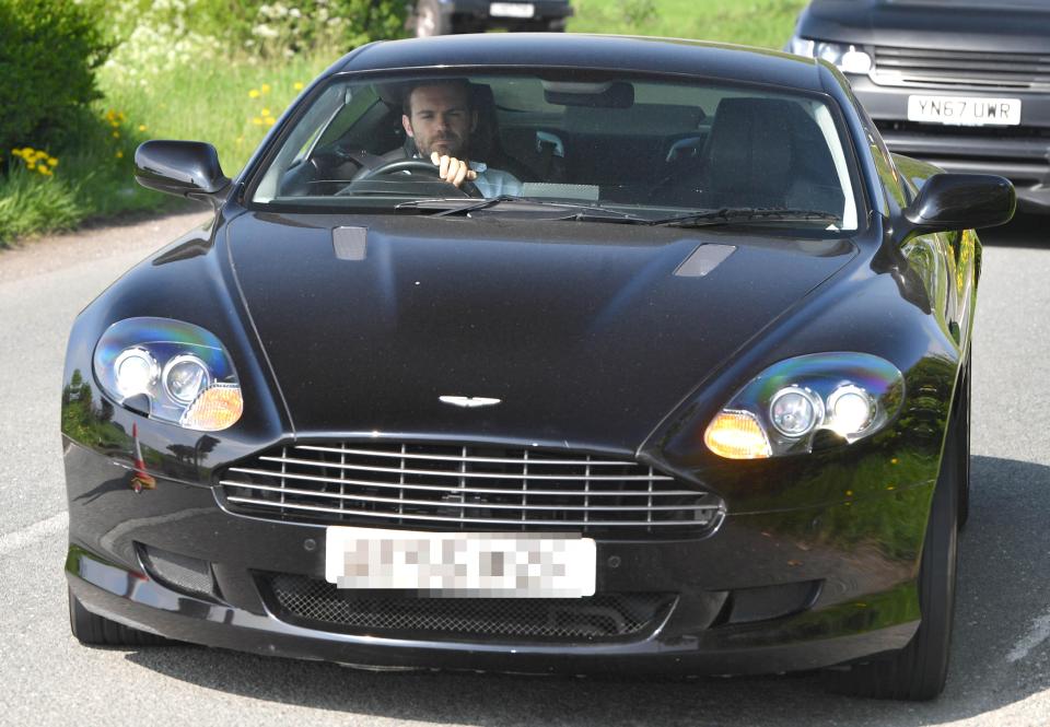 Juan Mata pulls in in his black Aston Martin