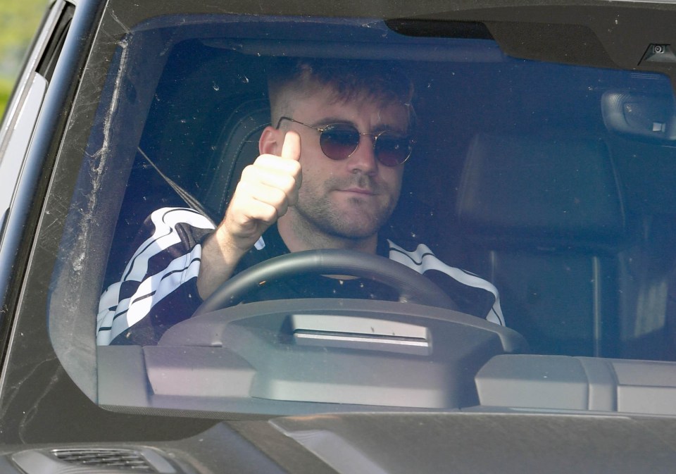 Luke Shaw gives the thumbs up as he rocks up to Carrington