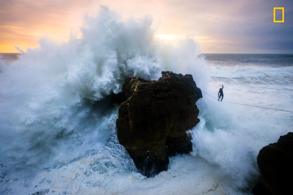  Andrey Karr photographed slackline walkers at sunset in Nazare, Portugal, as massive waves dwarfed them in the background