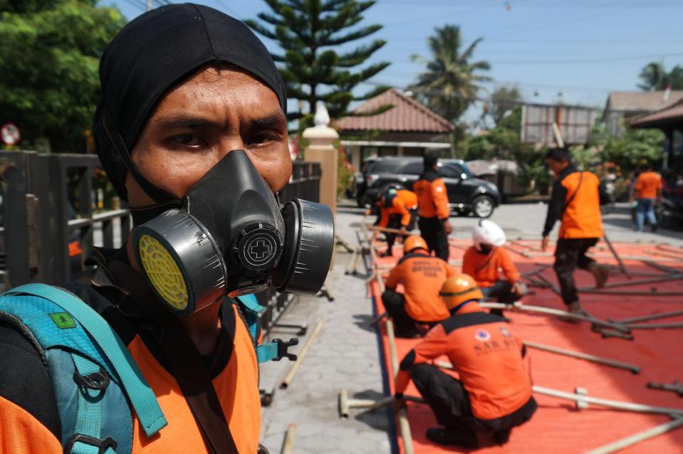  Emergency workers helped thousands of villagers to safety as ash rained down