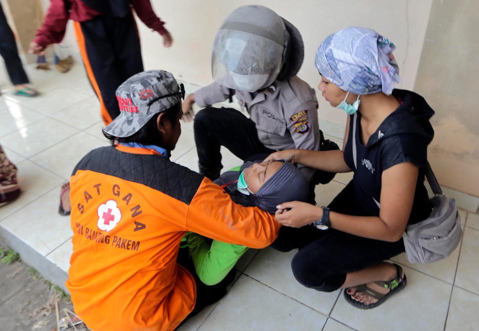  Medics treat a woman who collapsed during the evacuation but no serious casualties were reported