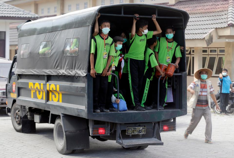  Evacuees wear face masks on the way to an emergency shelter today