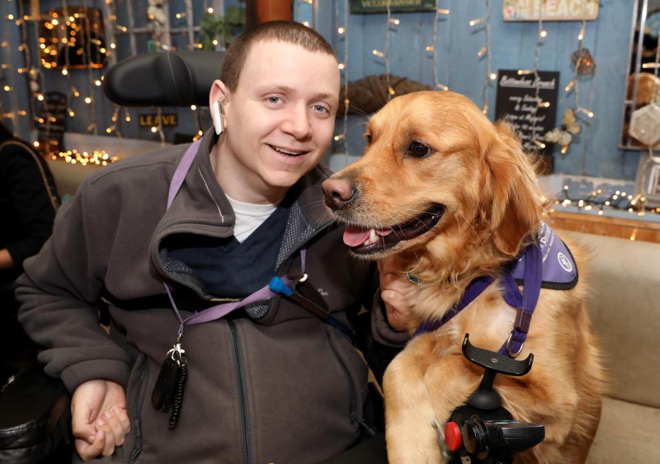  Tetraplegic footie fan Paul Phillips, 25, from St Albans, Herts, can now live independently with the help of Ralph, a retriever