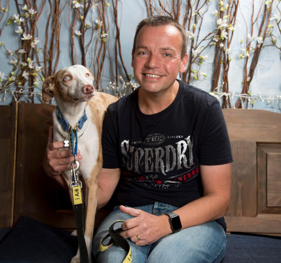  Paul Ison, of Hinckley, Leics, with his pet pooch, Scout. The lurcher is blind but has become a dementia therapy dog and raised money for ­charities