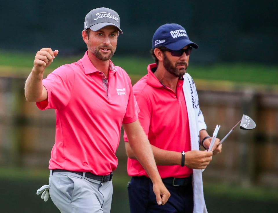  Webb Simpson celebrates as he walks off the eighteenth green with Paul Tesori - the caddie was paid £140,000 for helping Simpson win the Players Championship