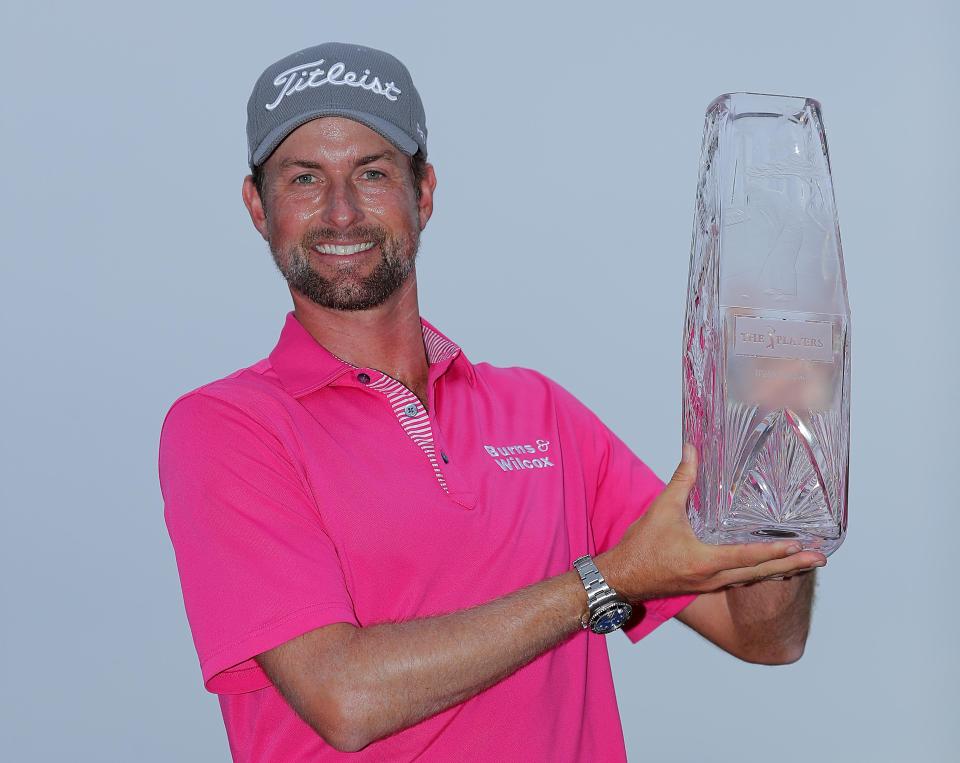  Simpson celebrates with the winner's trophy after the final round