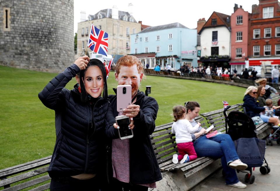  People pose with Harry and Meghan masks just days outside Windsor Castle before the wedding