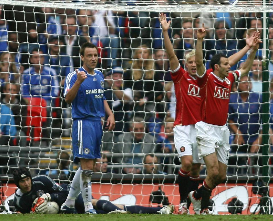  Giggs, 44, reacts as referee Steve Bennett waves play to continue at Wembley