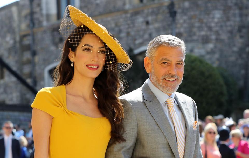  She wore her brunette locks in her signature style - loose and wavy - while George complimented her look with a striped yellow tie