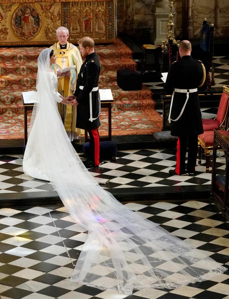  Harry and Meghan clasp hands as they exchange vows