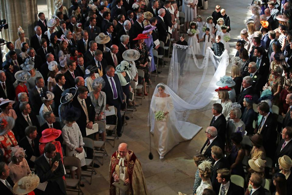  Meghan Markle's long 15ft veil, held by page boys John and Brian Mulroney, featured flowers from all the Commonwealth countries