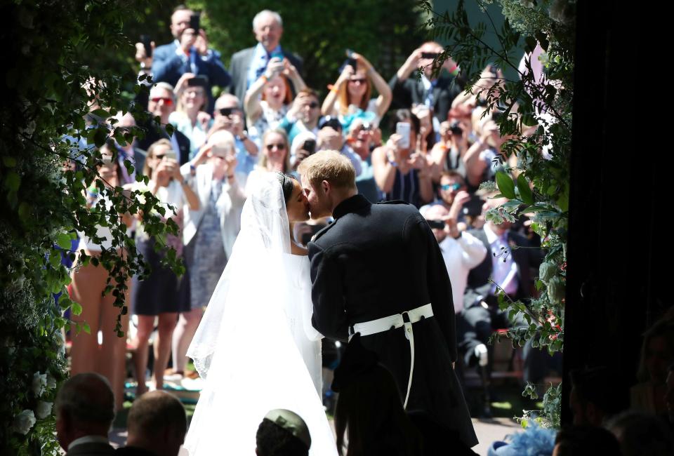  Waiting well-wishers snapped the happy couple as they emerged for a kiss on the steps of Windsor