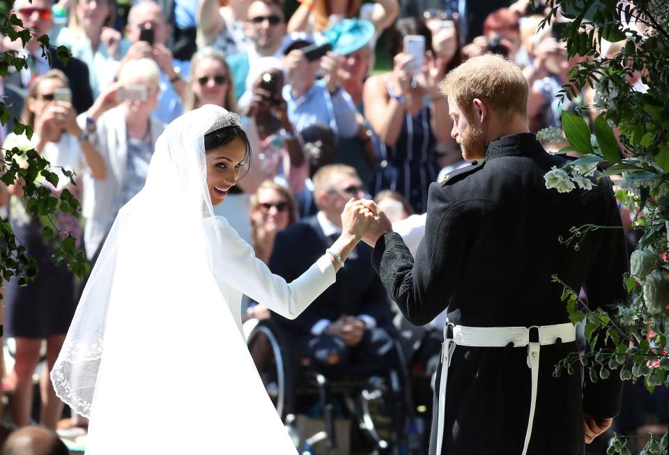  Meghan and Harry are welcomed by crowds outside St George's Chapel. They rounded off their wedding with a rousing rendition of the National Anthem