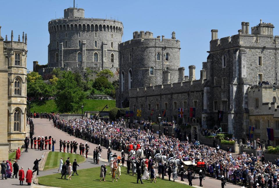  Windsor Castle is seen in the background as procession is led through the historic town