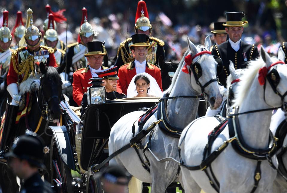  Harry and Meghan smile with joy as well-wishers greet them on the streets of Windsor