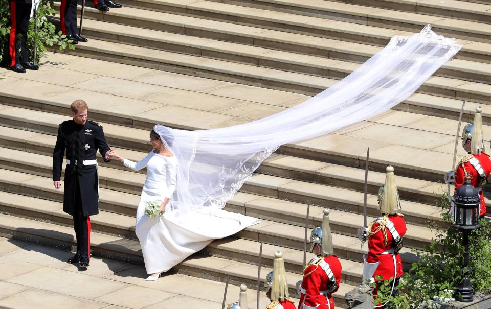 Prince Harry holds his bride's hand with the wedding having seen more than 100,000 people turning out to see the couple