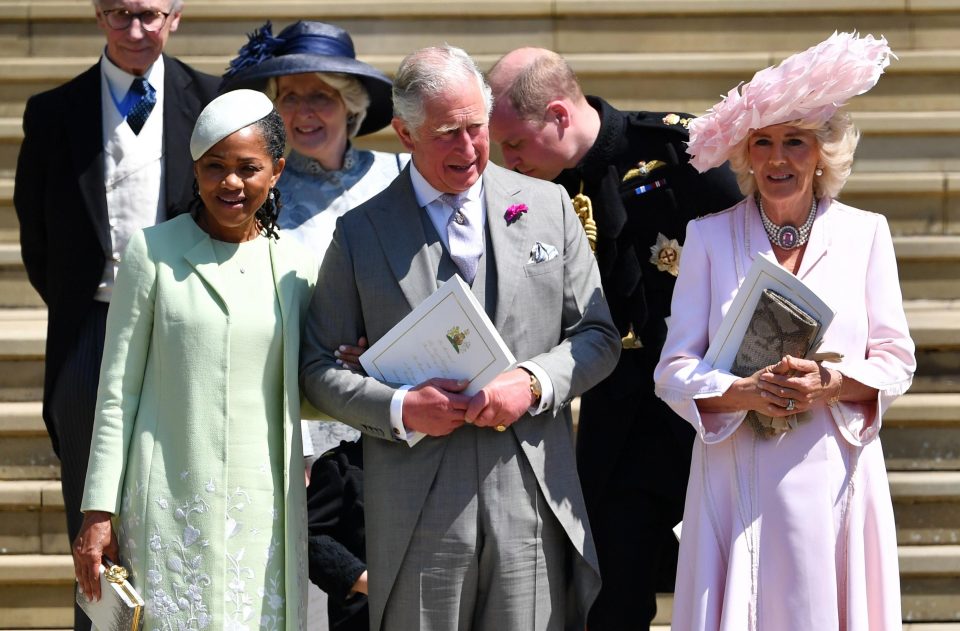  Doria holds onto Prince Charles as they walk down the steps outside St Georges Chapel