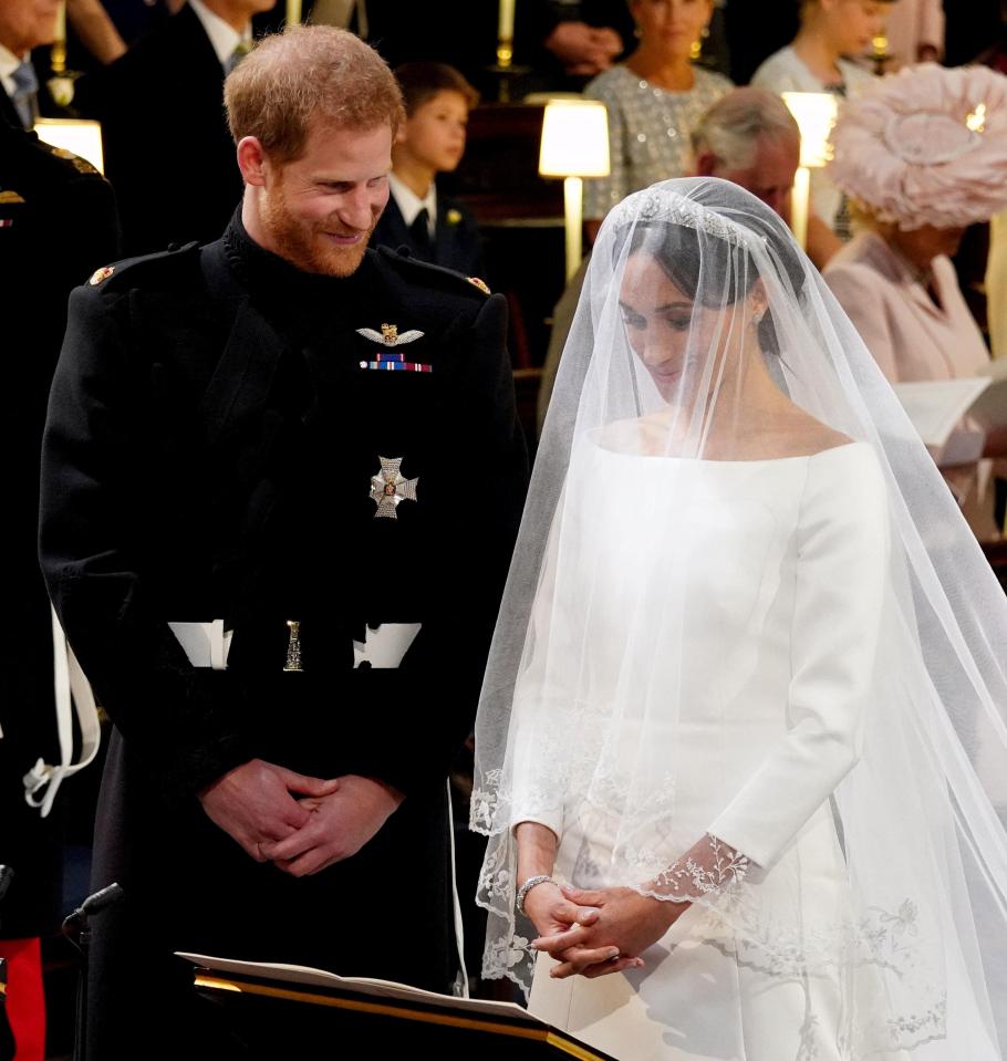  Prince Harry and Meghan beam as they prepare to say their vows