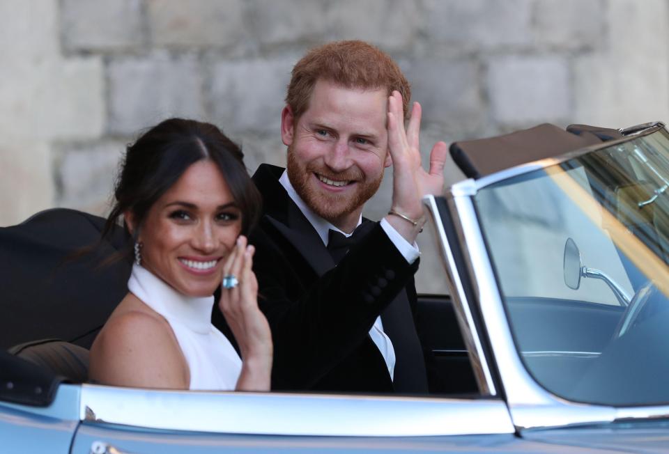  The royal couple wave to fans as they leave Windsor Castle for the evening reception