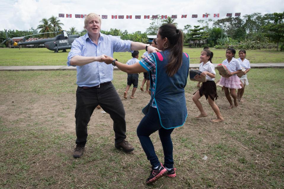  Foreign Secretary Boris Johnson dances with infant class teacher Adriana Pinedo during a visit to the village school in Santa Marta, on the bank of the Amazon near Iquitos in Peru, where he saw a UK-funded solar energy project which has provided the school with electricity and fresh water