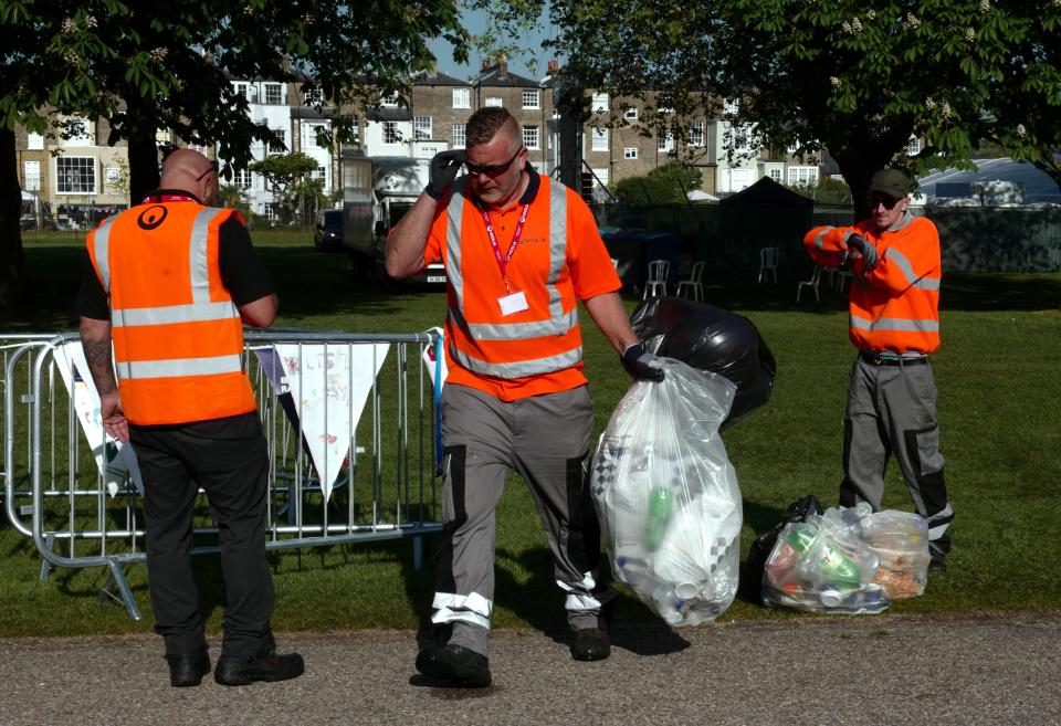  Workers filled bin bags with rubbish from the grassy fields where more than 120,000 gathered