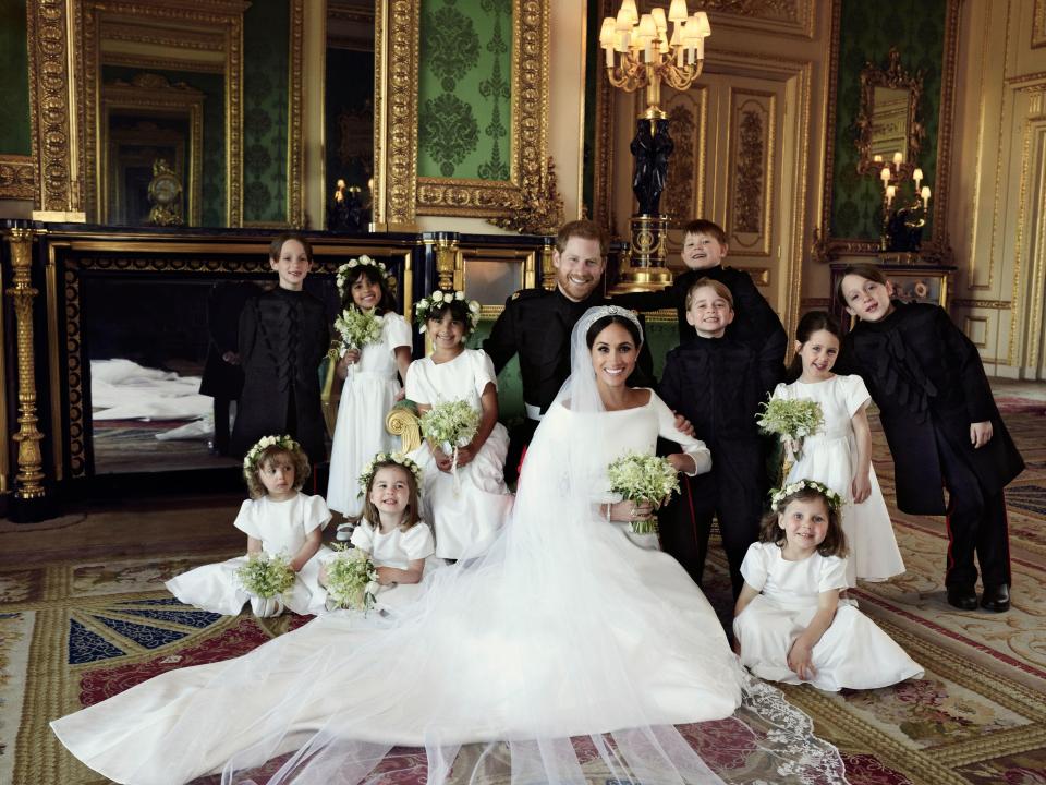 The Duchess of Sussex poses with her new husband and bridesmaids and pageboys, who include Princess Charlotte and Prince George