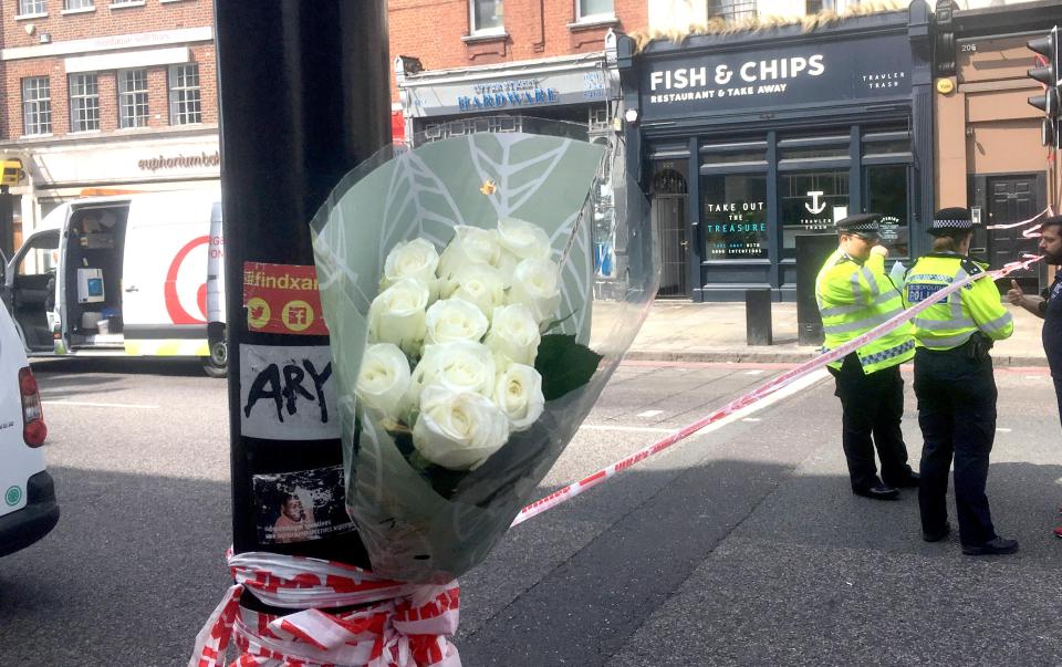 Flowers are tied to a lamp post in Islington in north east London where a man was murdered during a stabbing attack