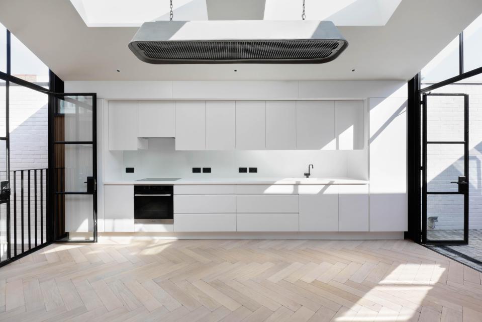  A sleek modern kitchen is located on the property's ground floor