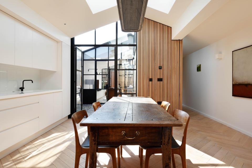  Floor-to-ceiling windows allow natural light to flood into the bright family home