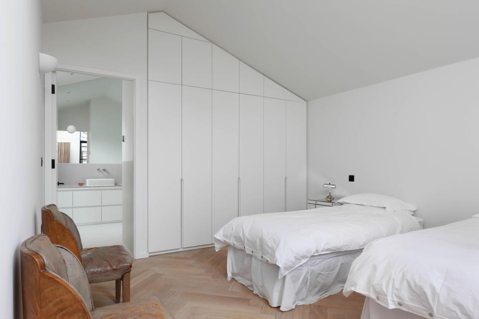  The stylish home boasts two sleek, white bedrooms