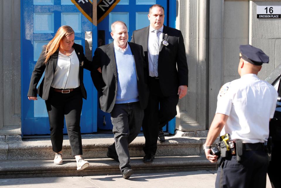  Harvey Weinstein is led out in cuffs after being charged with rape and sexual assault against two women. He has pleaded not guilty to all charges