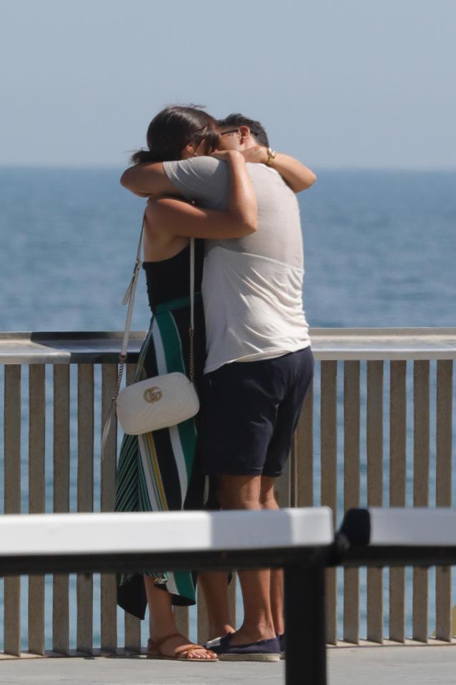  They stopped their stroll for a smooch under the Spanish sun