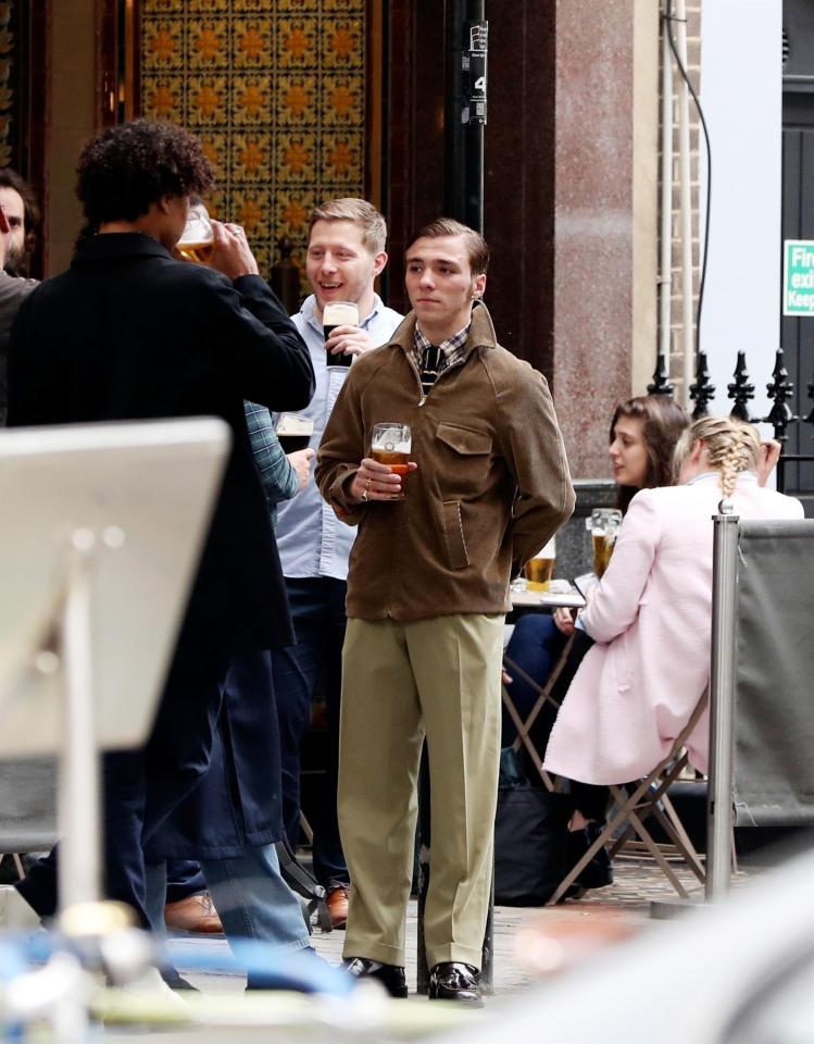  He chatted away to a mate outside a pub in Soho