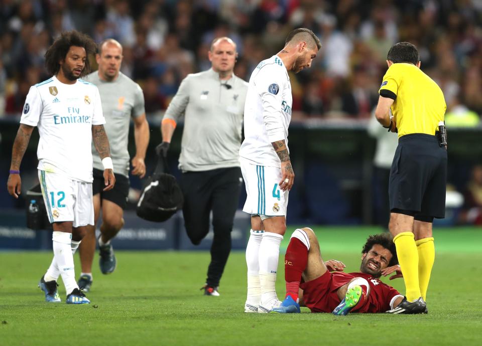  Ramos stands over Salah after the Liverpool players crashed to the ground