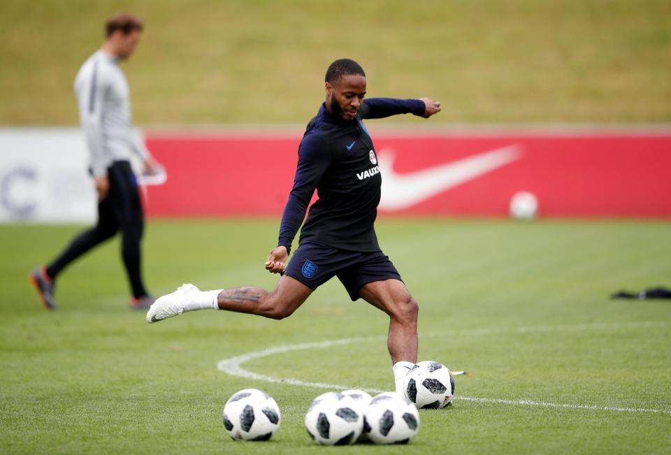  Manchester City winger Raheem Sterling showed off his new assault rifle tattoo during today's England training session