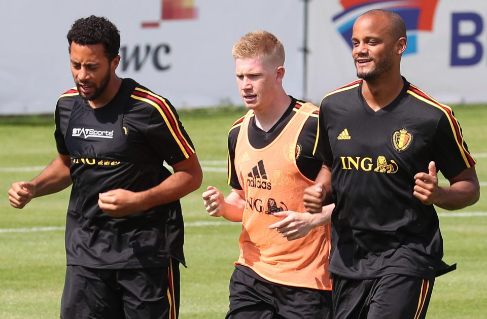  Belgium's Mousa Dembele, Kevin De Bruyne and Vincent Kompany limber up to face Portugal