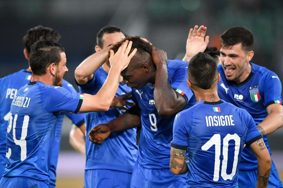  Balotelli is congratulated after scoring for Italy in his first appearance for almost four years