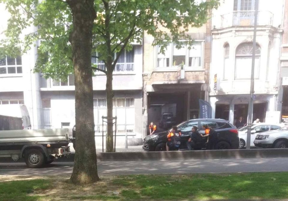  Police take cover during the incident in Liege