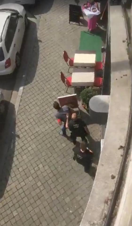  Emergency responders take cover during the suspected terror attack in which two police officers were killed this morning