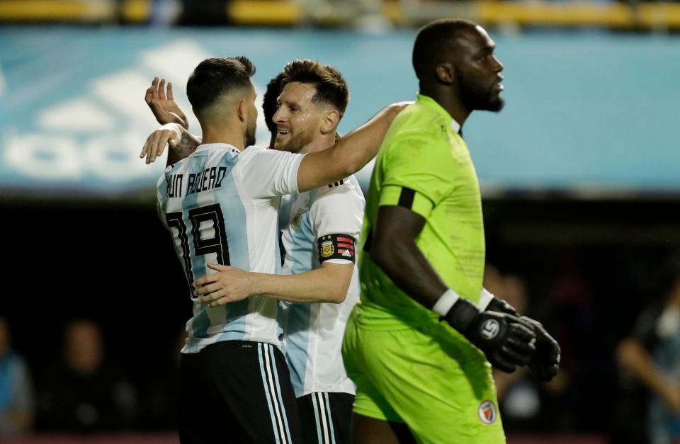  Lionel Messi congratulates Sergio Aguero on Argentina's fourth goal